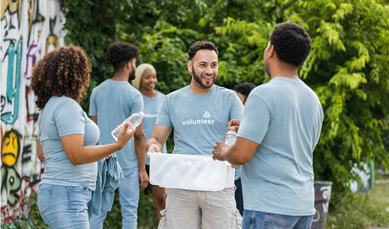 Group of people volunteering together, representing the SLB community spirit