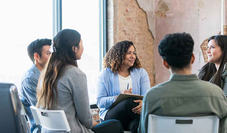 Group of people engaged in discussion, representing spouse-partner association